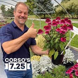 Chad Corso gives a thumbs-up sign while holding a blooming double scoop deluxe plant.
